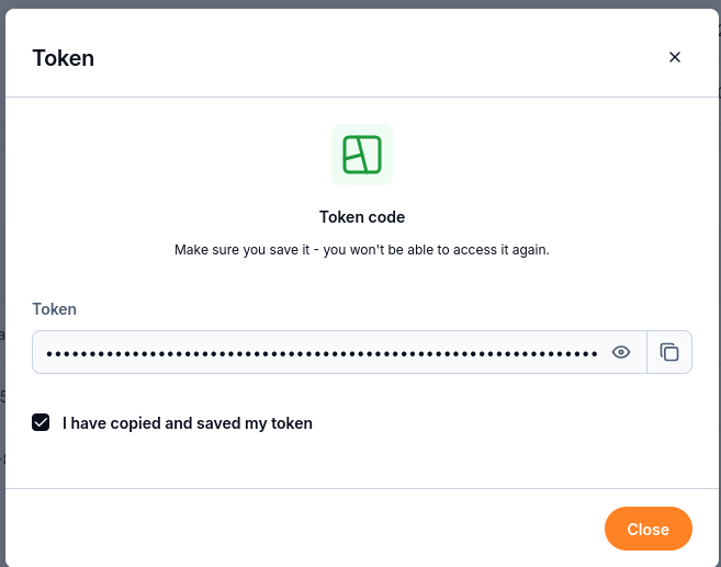 Copy and save the token before closing the dialog; its value is masked in this screenshot.