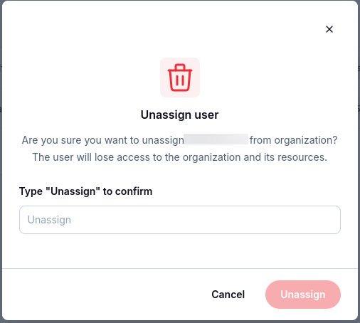 Unassign user confirmation requiring the text Unassign and warning that organization and resource access will be lost.